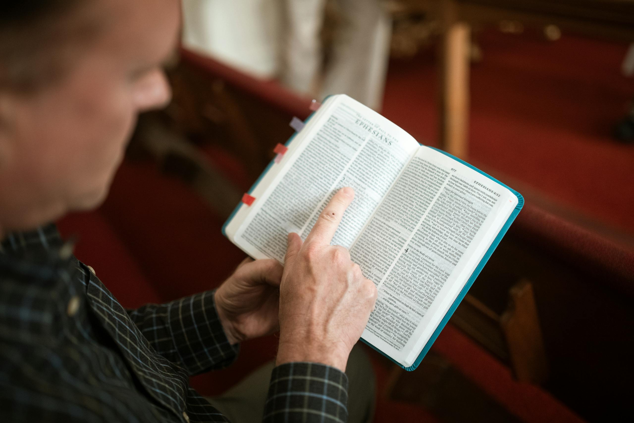Close-Up Shot of a Person Reading a Bible